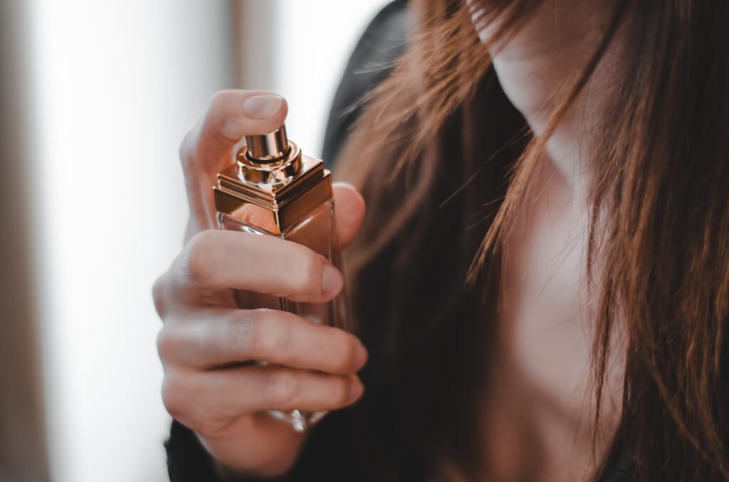 Perfume bottle in woman hands